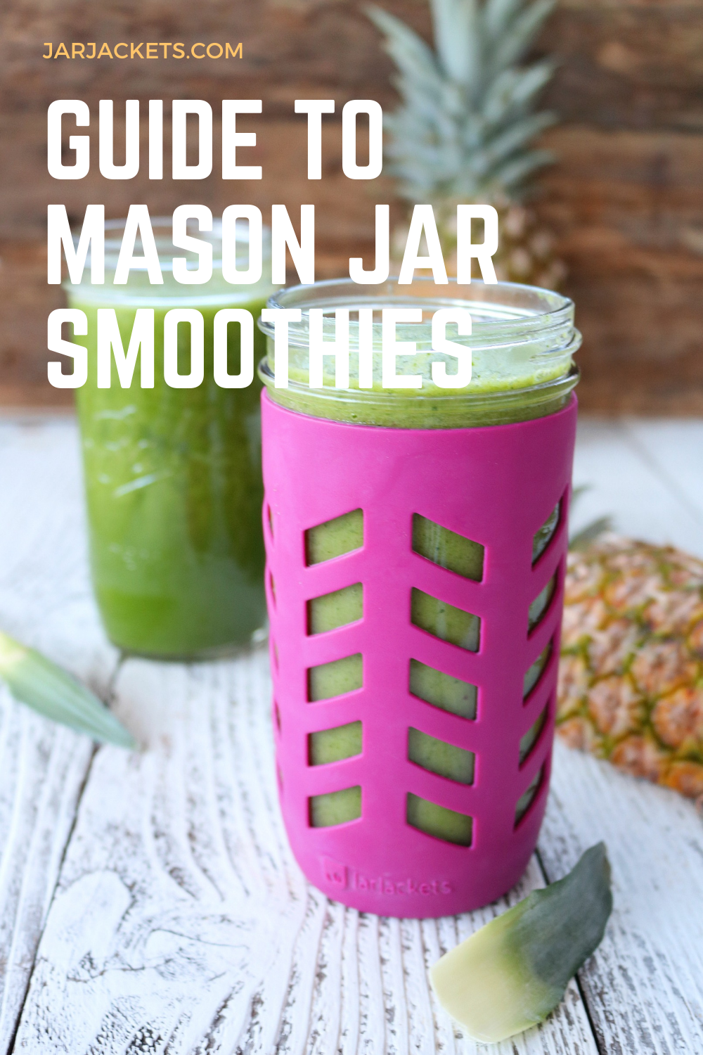 Two green smoothies are on a table in Mason jars.