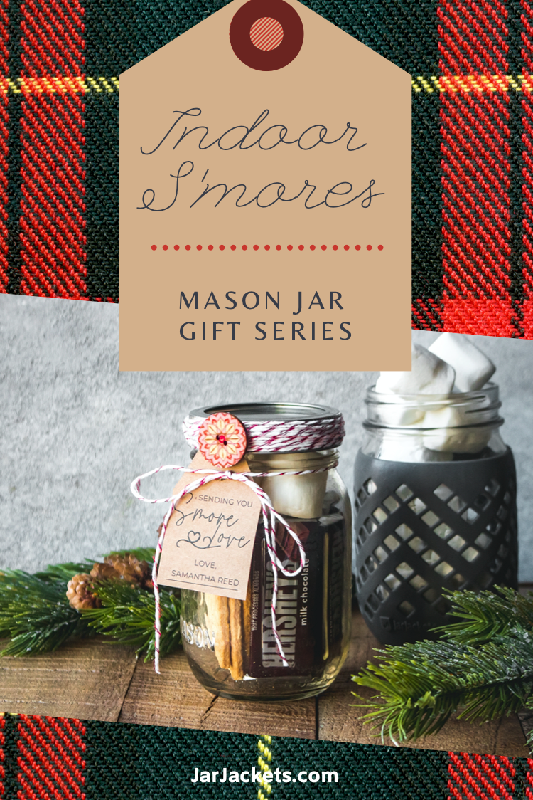 A mason jar filled with Hershey’s bars, marshmallows and graham crackers and decorated with a gift tag and festive twine.